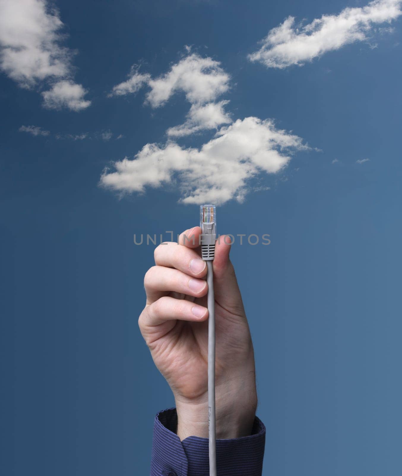 Cloud computing concept. Hand with ethernet cable connecting into cloud.