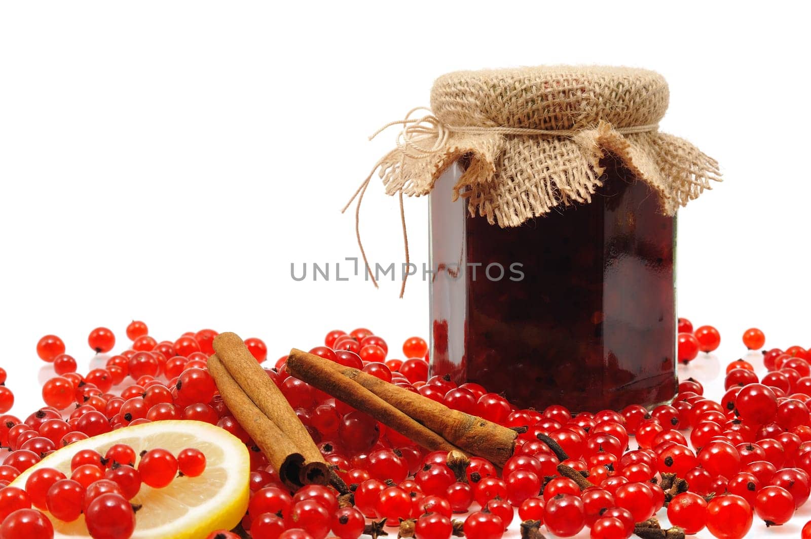 Jar of homemade red currant jam with fresh fruits