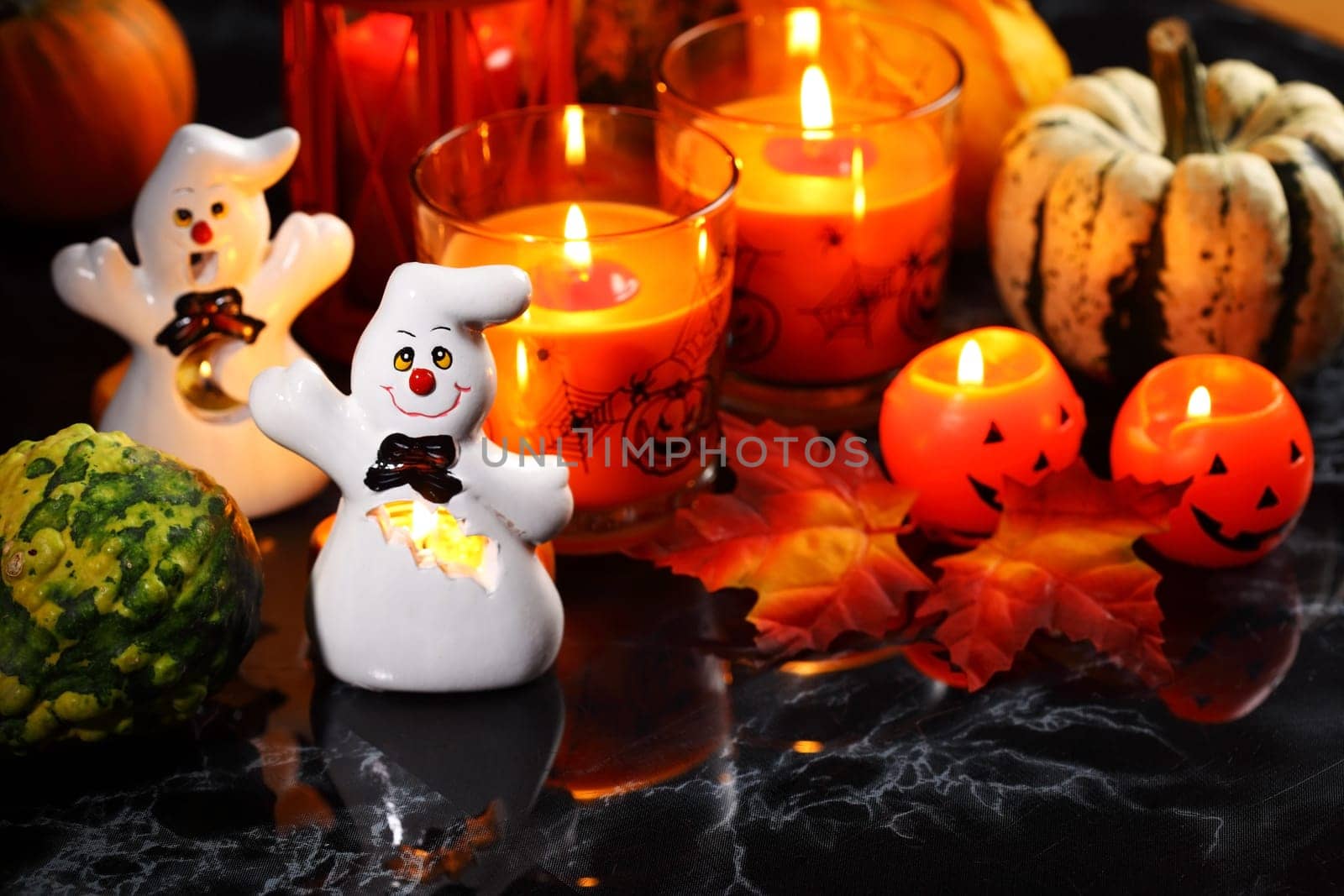 Halloween candle-light with pumpkins on black background
