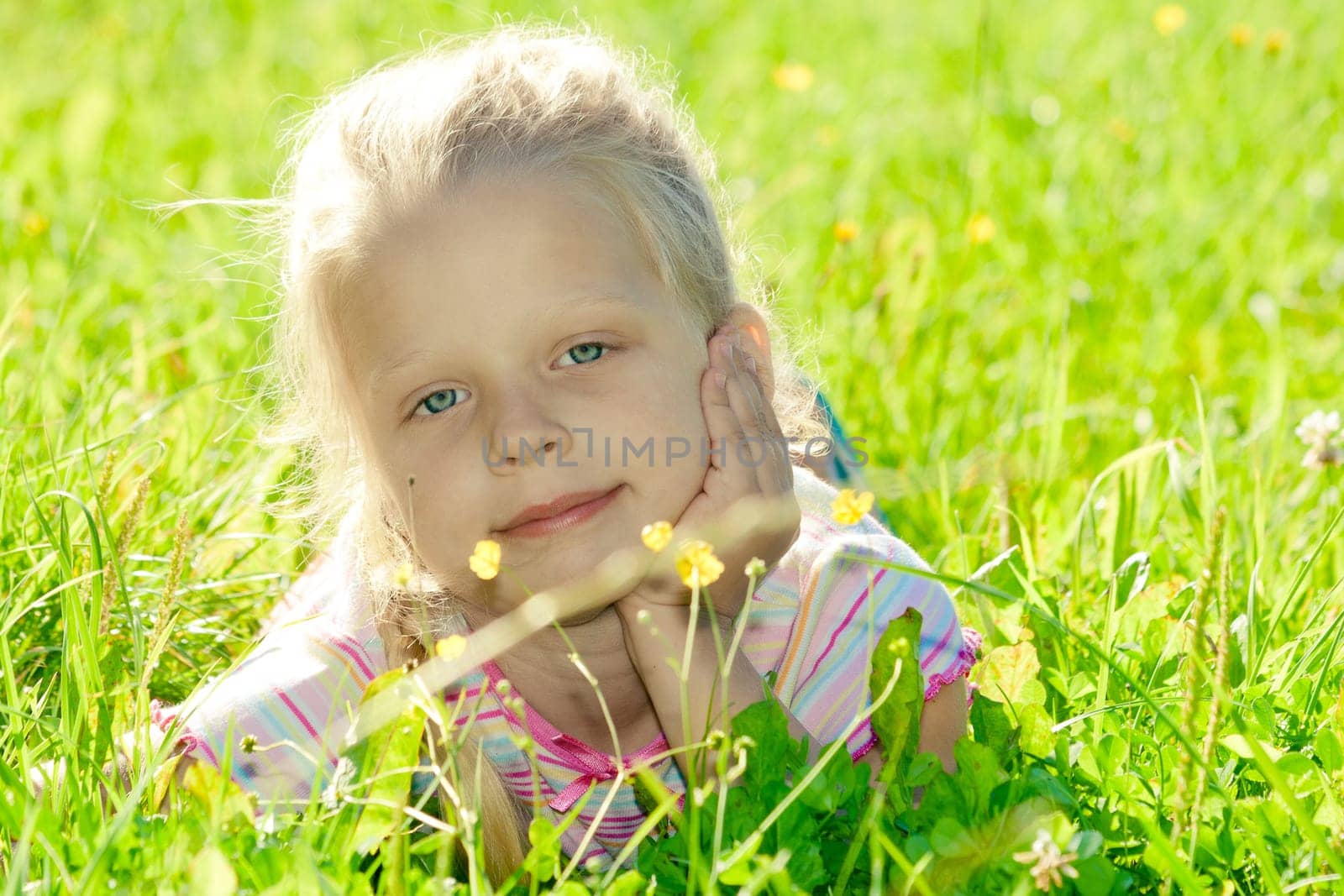 Little girl lying on grass