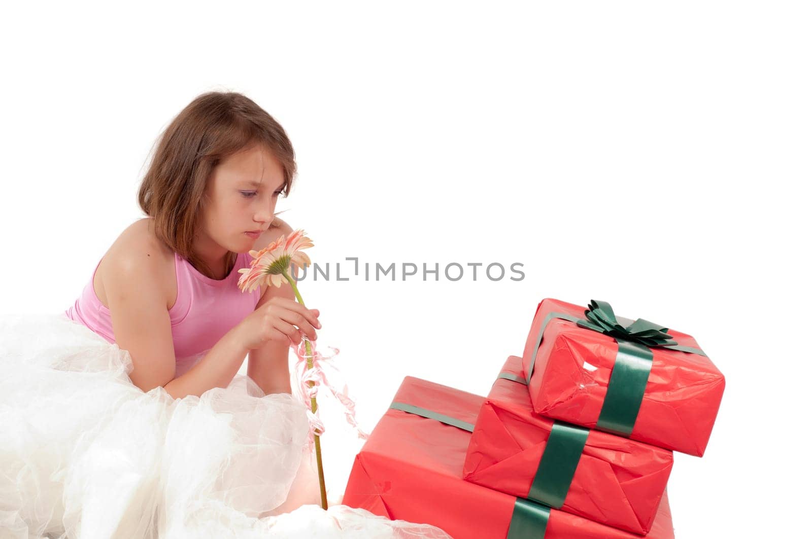 Teenager girl with presents in studio isolated on white