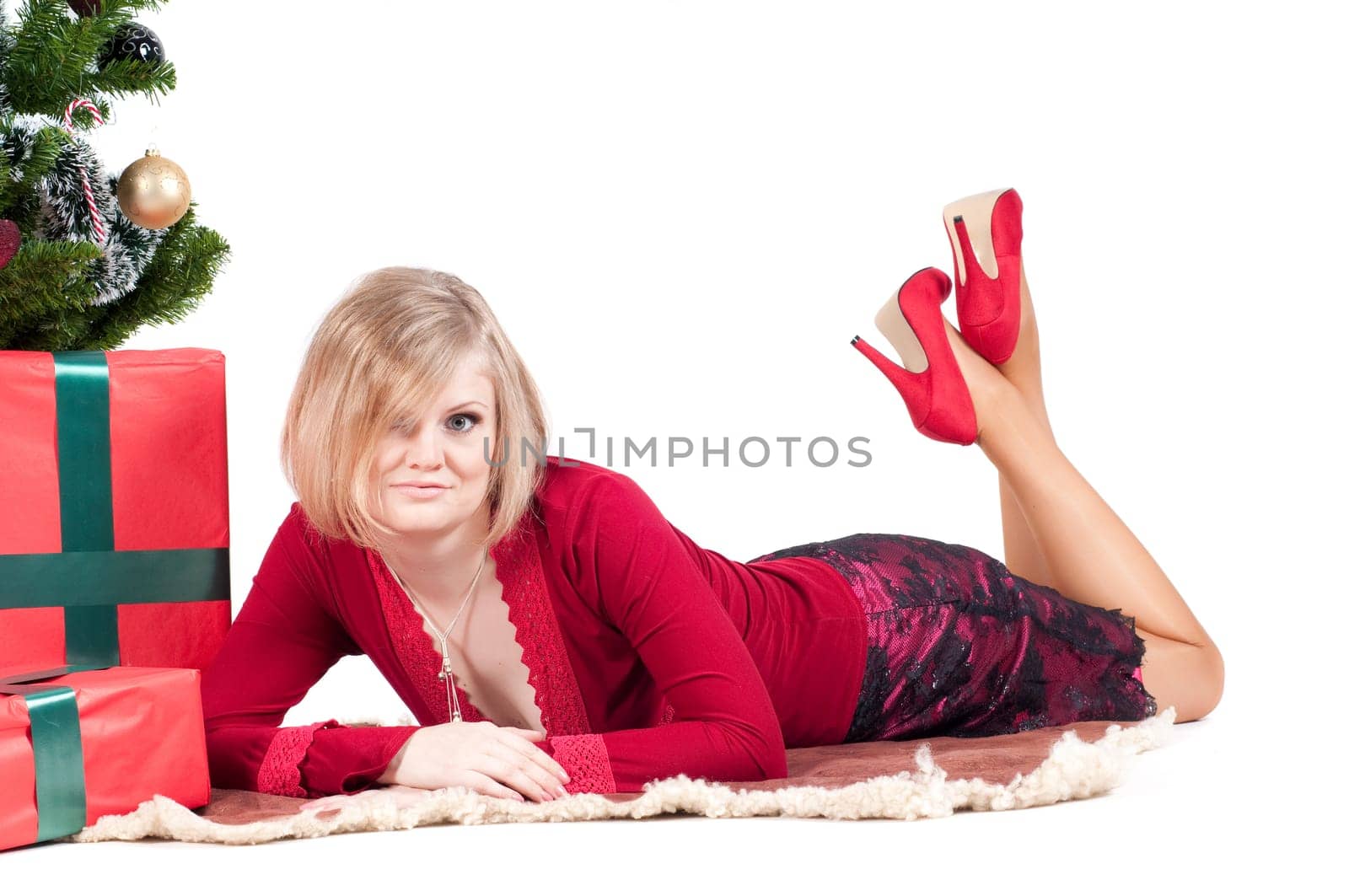 Happy woman with Christmas presents and tree isolated on white