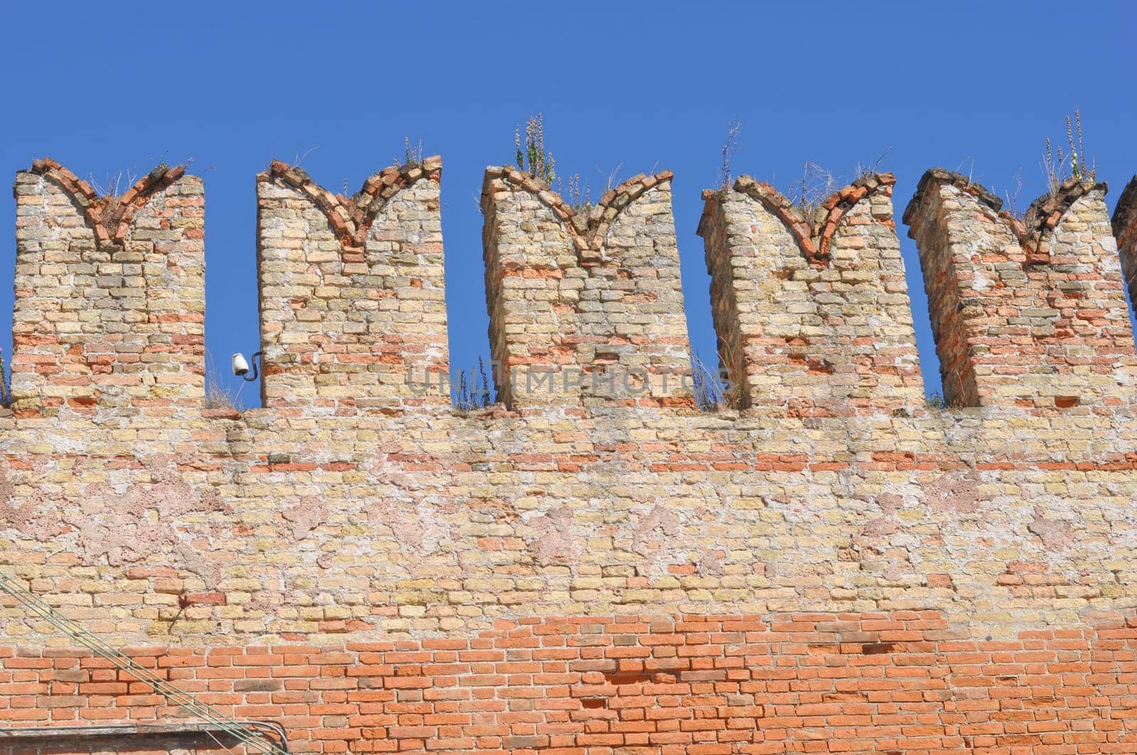 Detail of ancient Medieval castle over blue sky