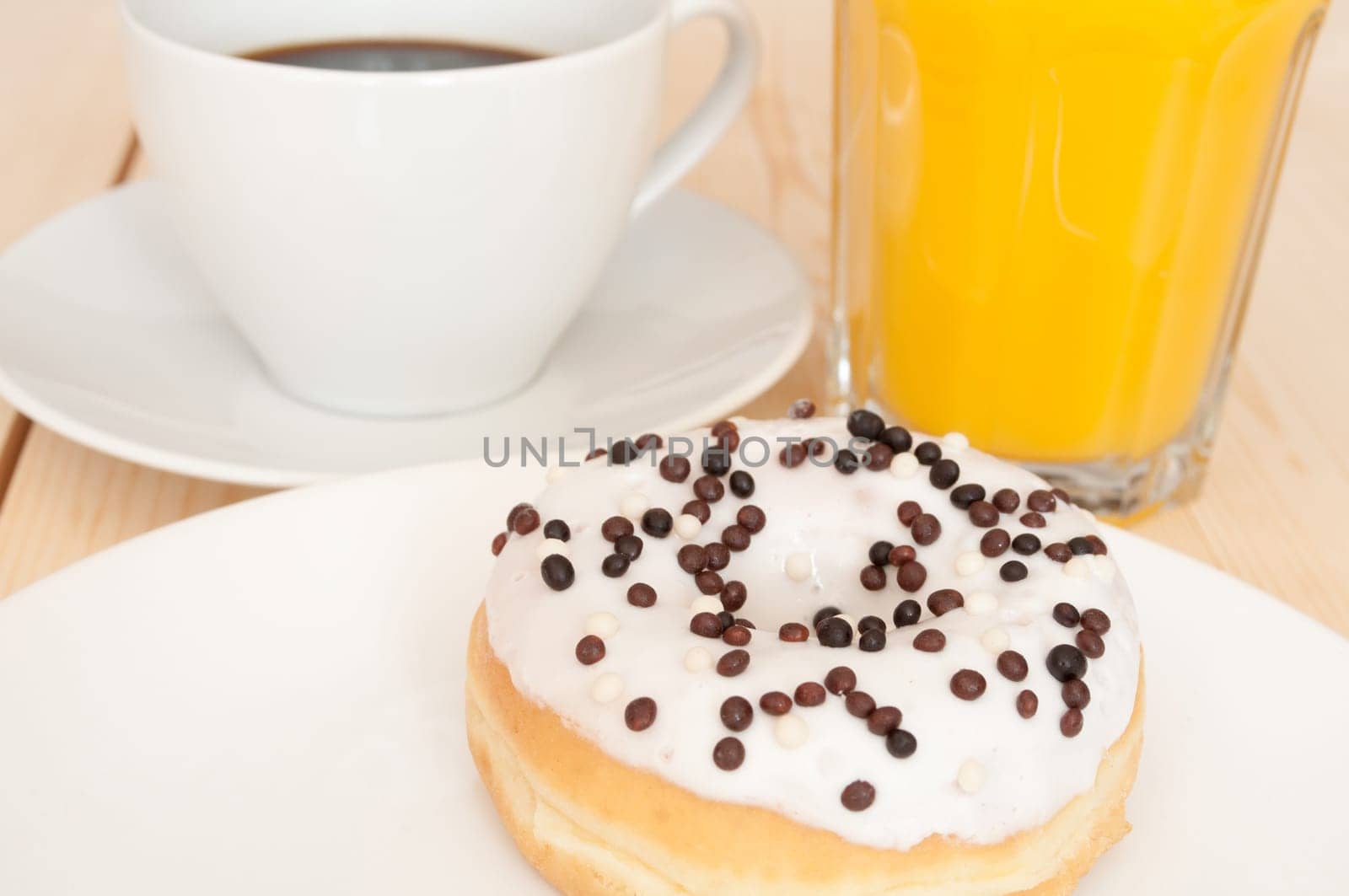 Breakfast - Donut, Coffee and Orange Juice on Wooden Table
