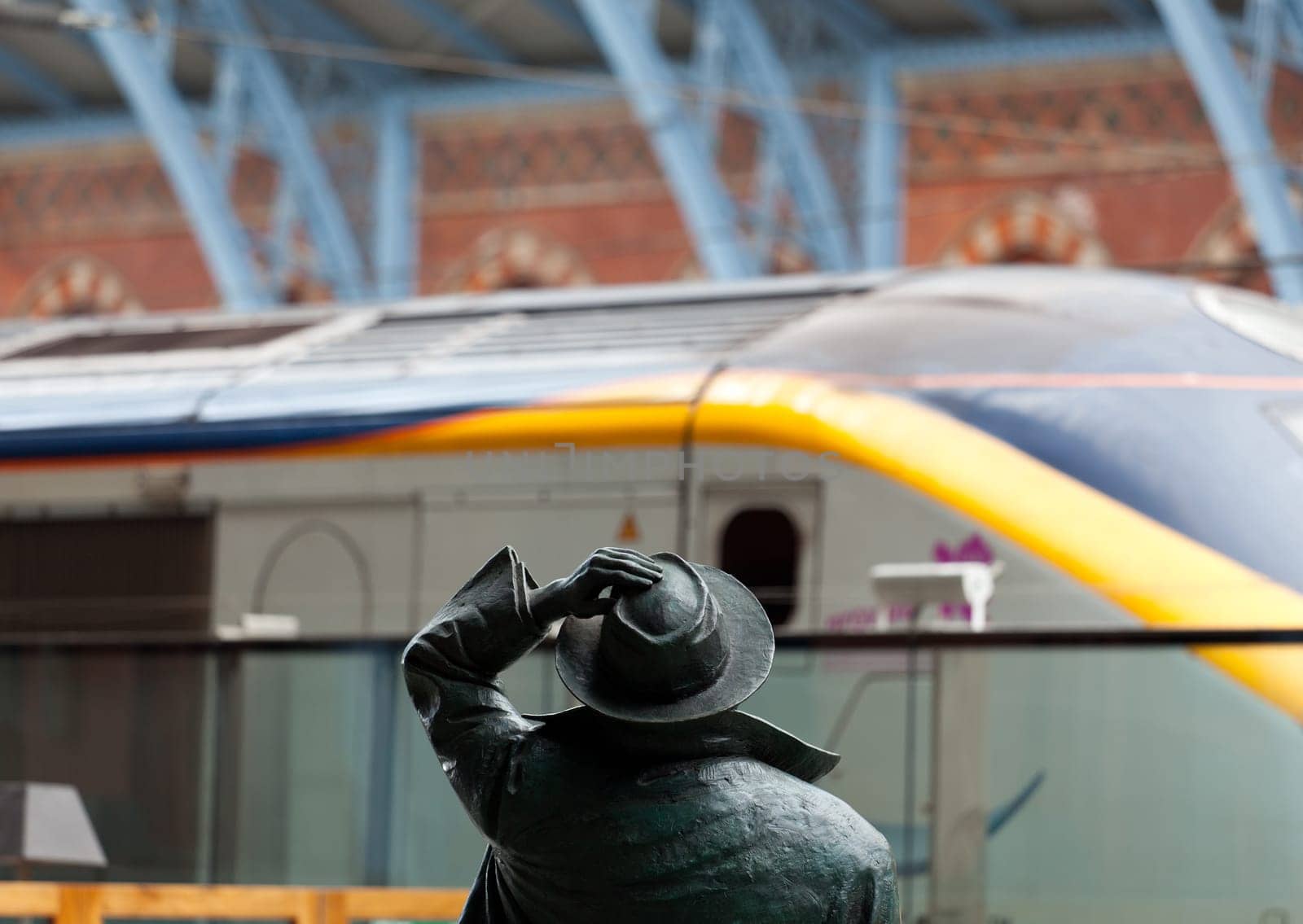 LONDON - SEPTEMBER 21: Betjeman statue in St Pancras Station on September 21, 2011. Arriving passengers from Eurostar to the new International Terminal are greeted by famous statue of John Betjeman.