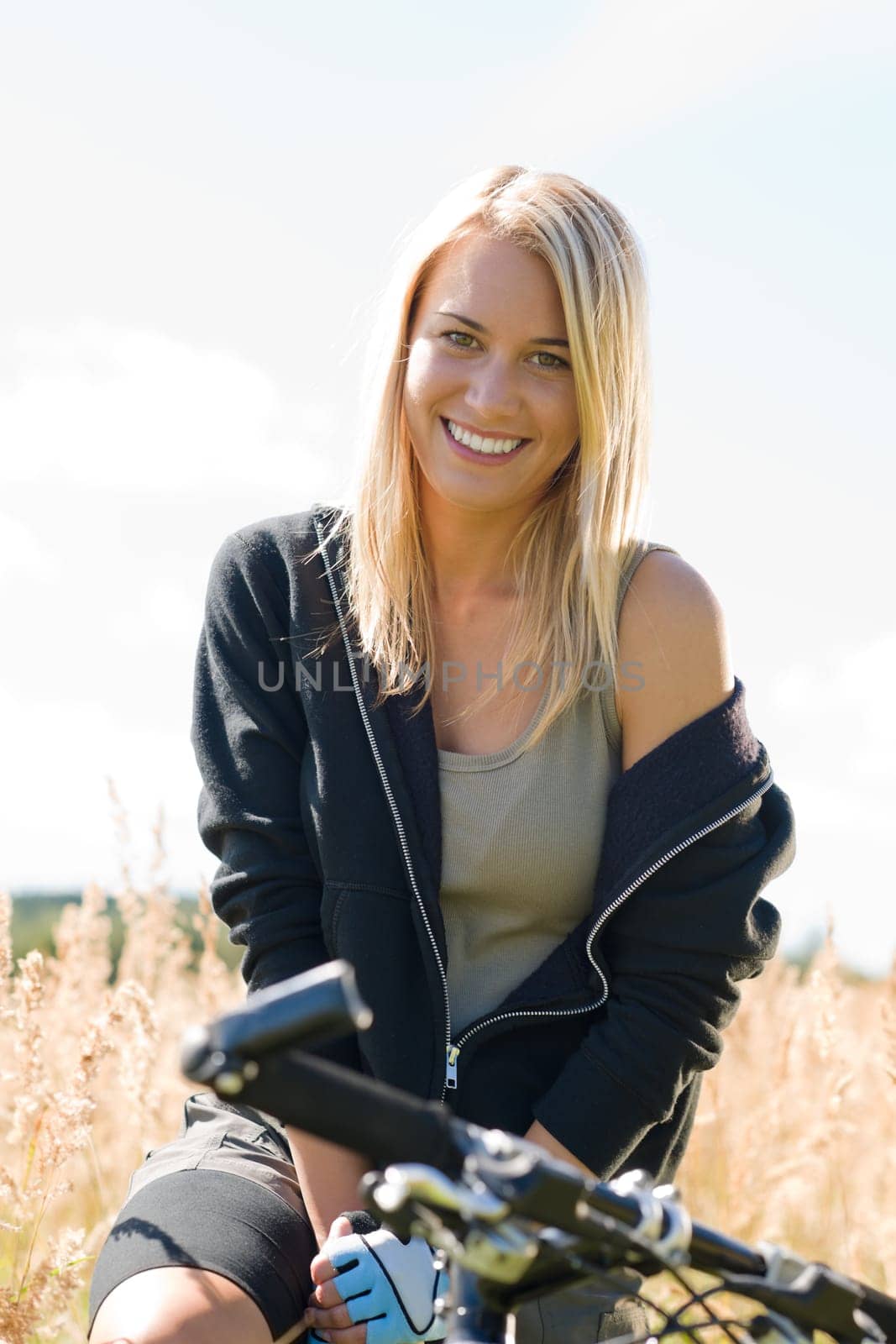 Mountain biking happy young woman relax in cornfield sunny countryside
