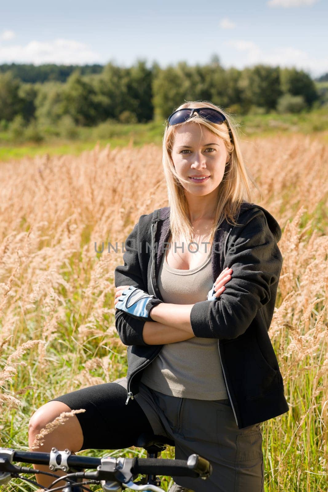 Mountain biking happy young woman relax in cornfield sunny countryside