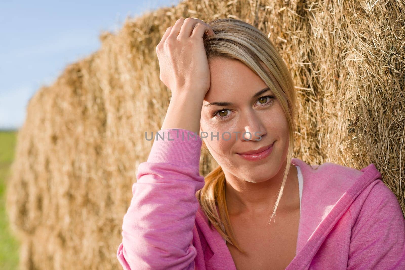 Sportive young woman relax lean against hay bales sunset countryside