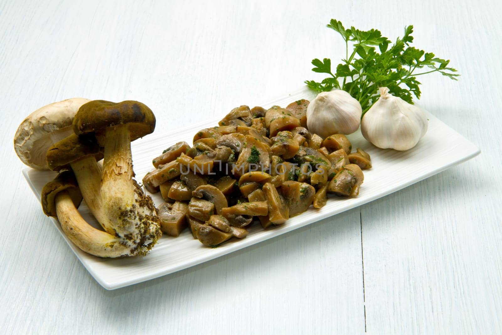 cooked and fresh mushrooms  with garlic and parsley