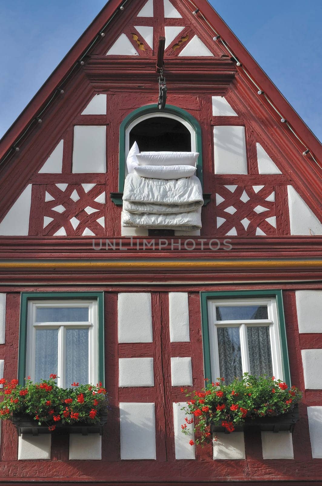 duvet exposed at a window of old wattle house in city center