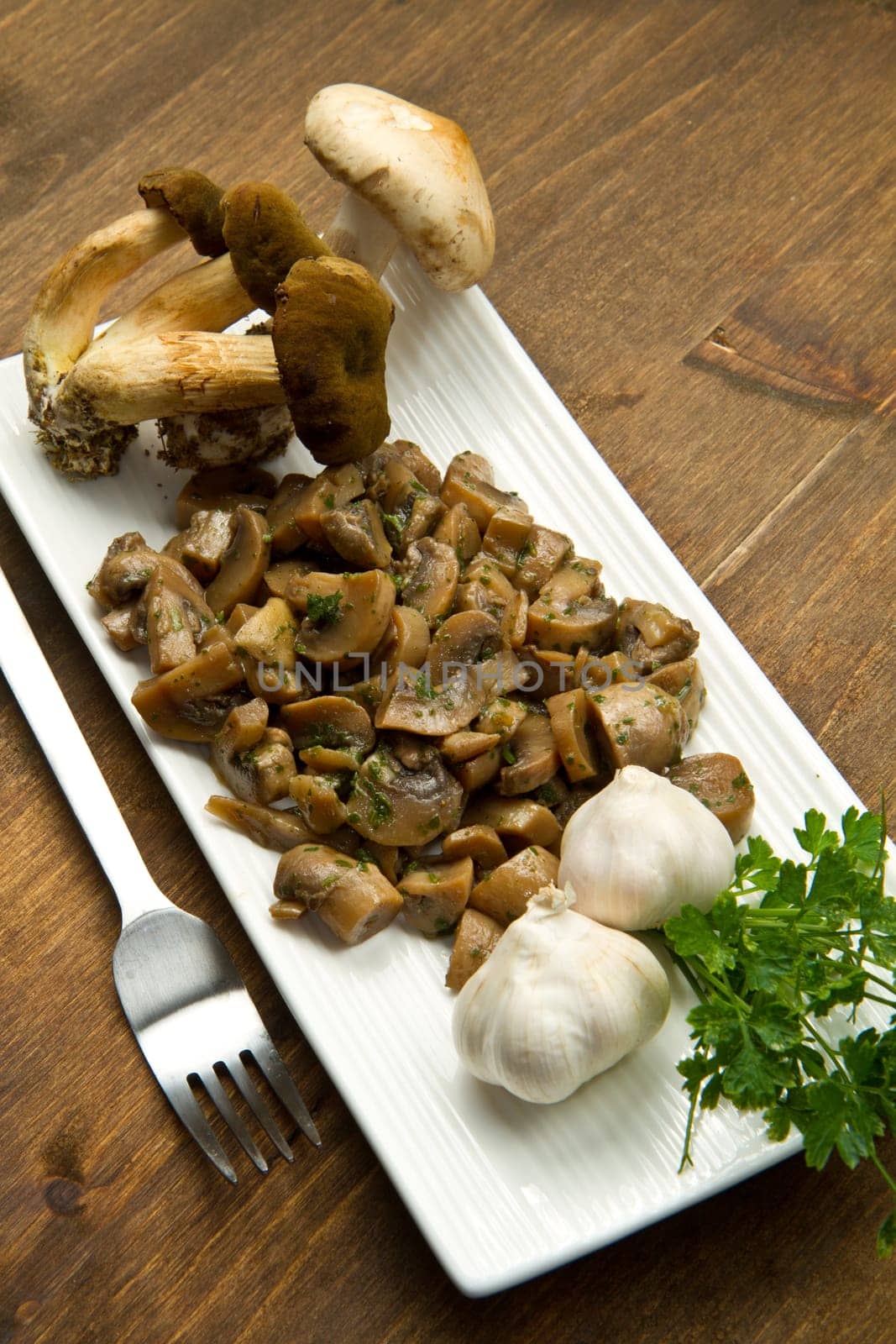 cooked and fresh mushrooms with garlic and parsley