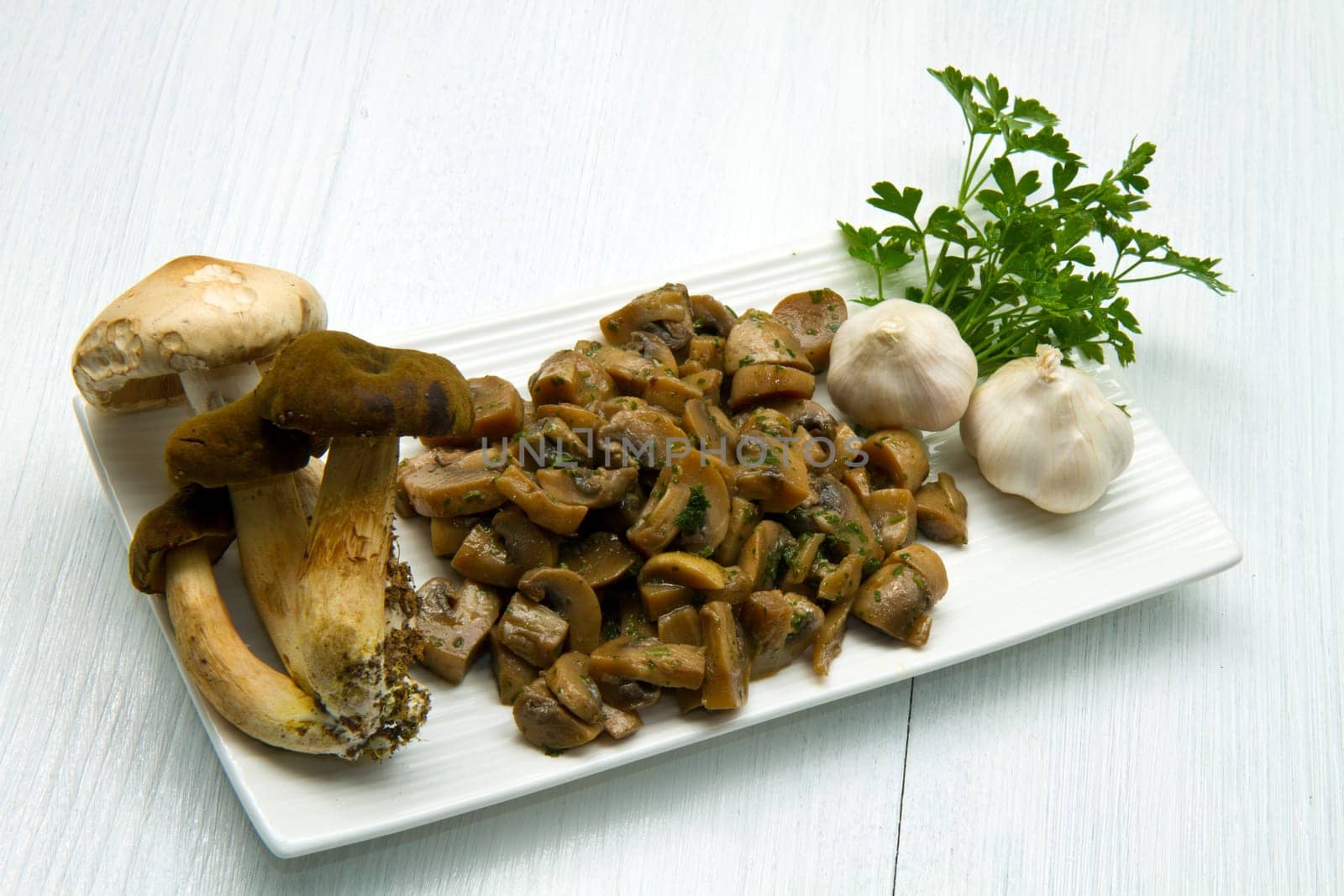 cooked and fresh mushrooms  with garlic and parsley
