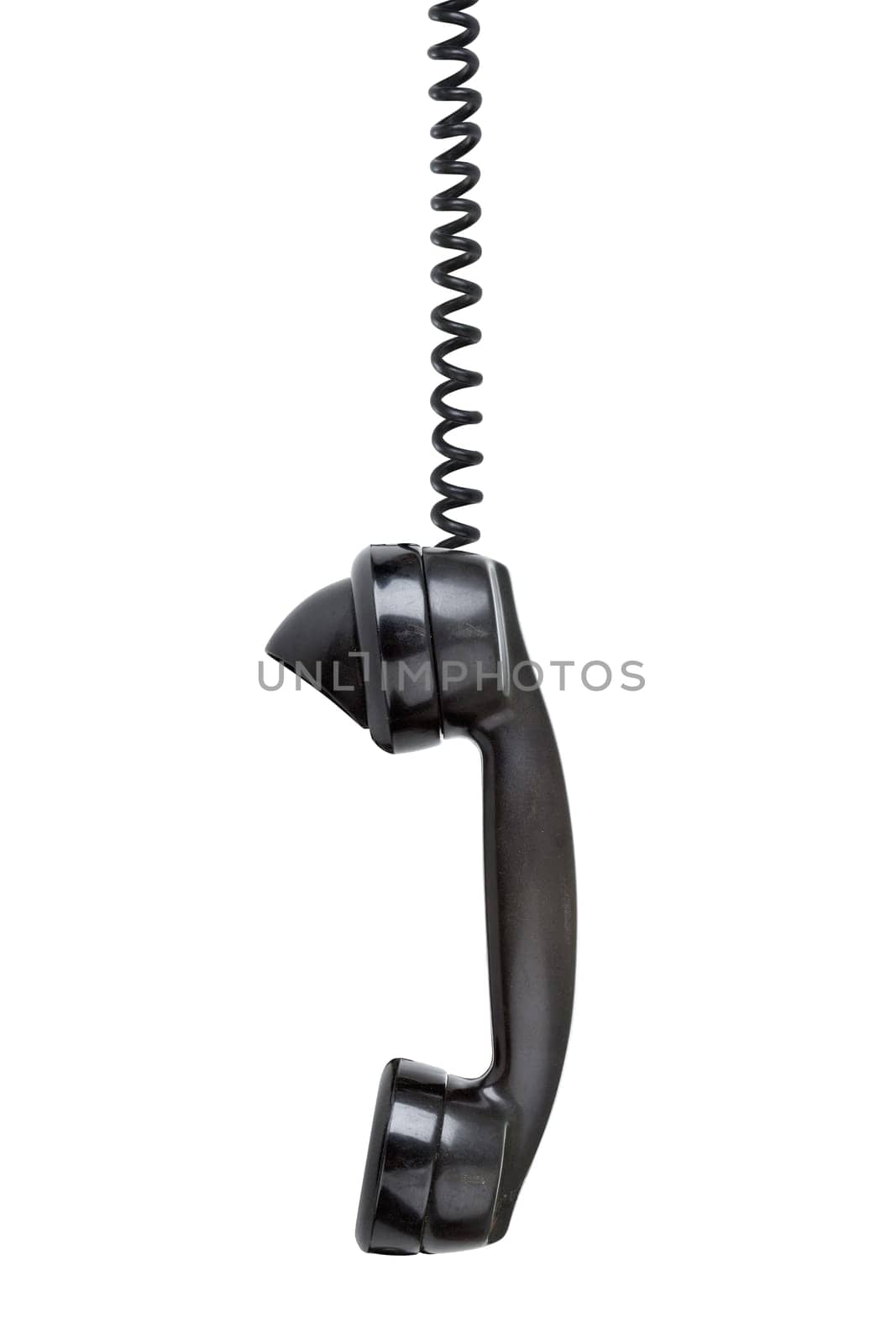 Old vintage phone with wear and tear hanging off the hook - sideview