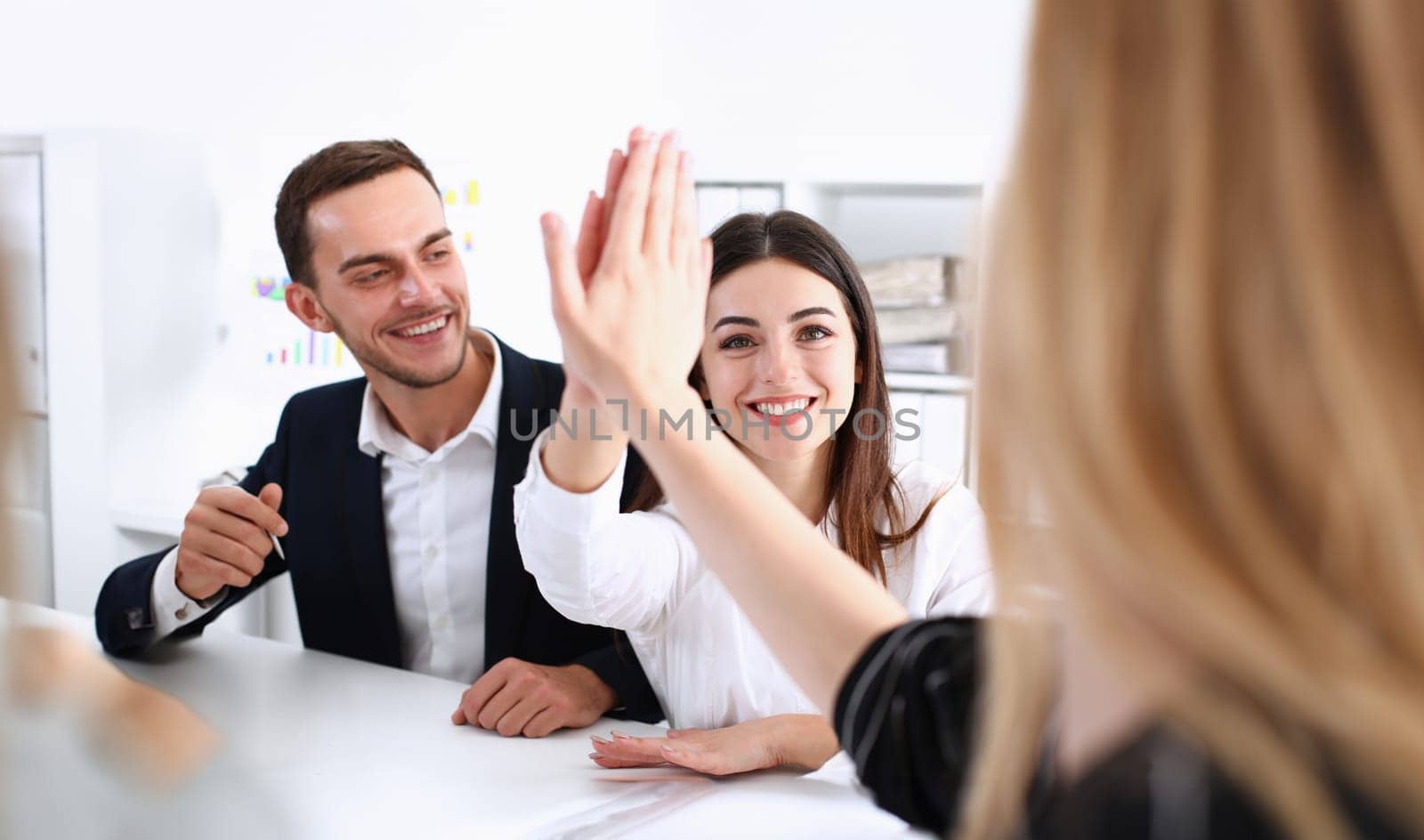 Group of joyful smiling happy people celebrate win with arms up. Mediation offer high five friendship deal achievement strike bargain good news friendly consent successful effective strategy