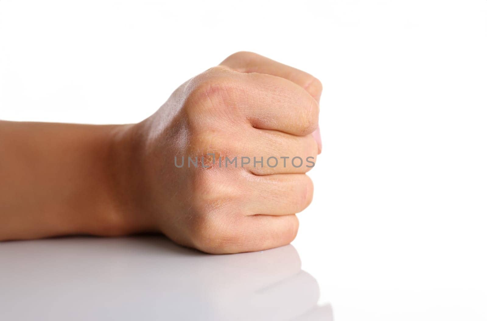 Male clenched fist isolated on white background closeup. Aggressive angry strong riot for freedom victory concept