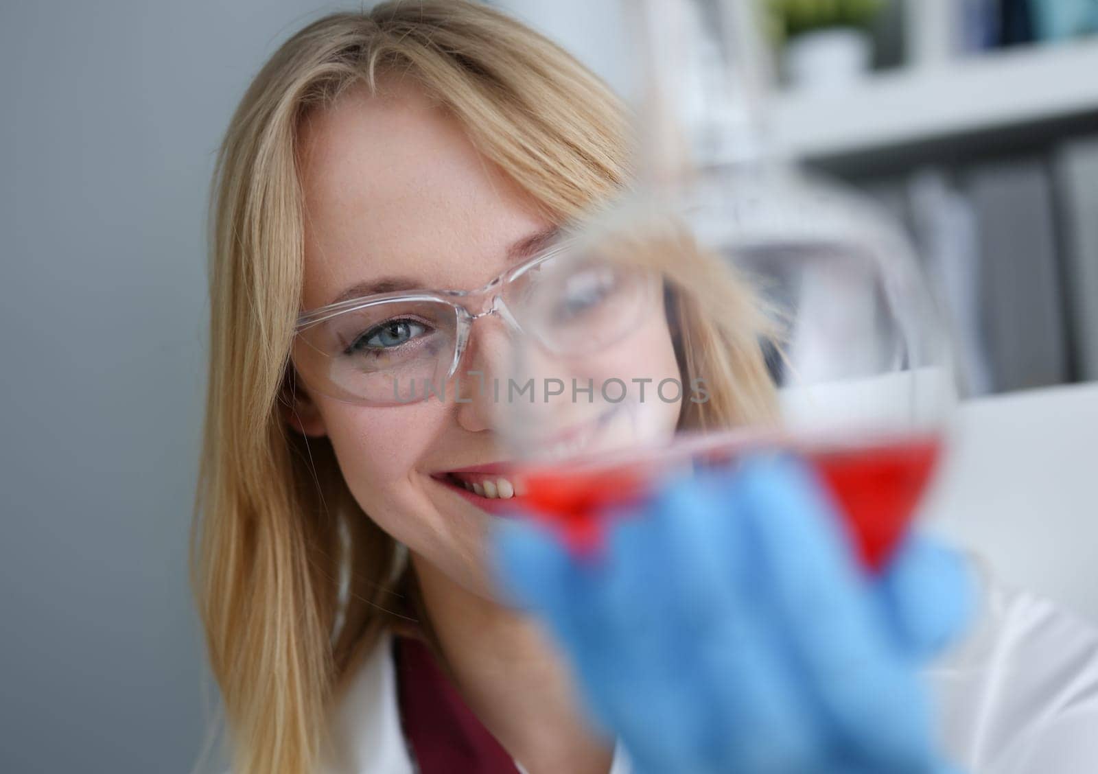 Technician hold in arms in protective gloves sample bottle with poison fluid portrait. Medical worker in uniform use reagent tube for virus infection exam or biological toxic reaction drug creation
