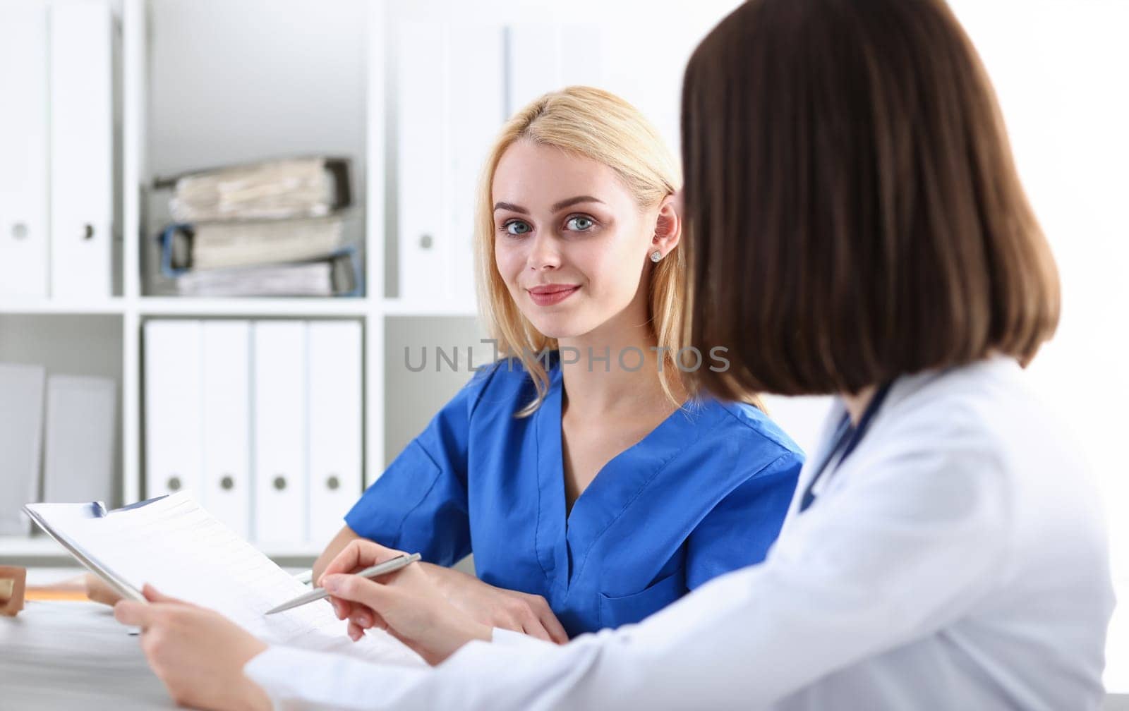 Group of doctors using laptop pc sitting by kuprevich