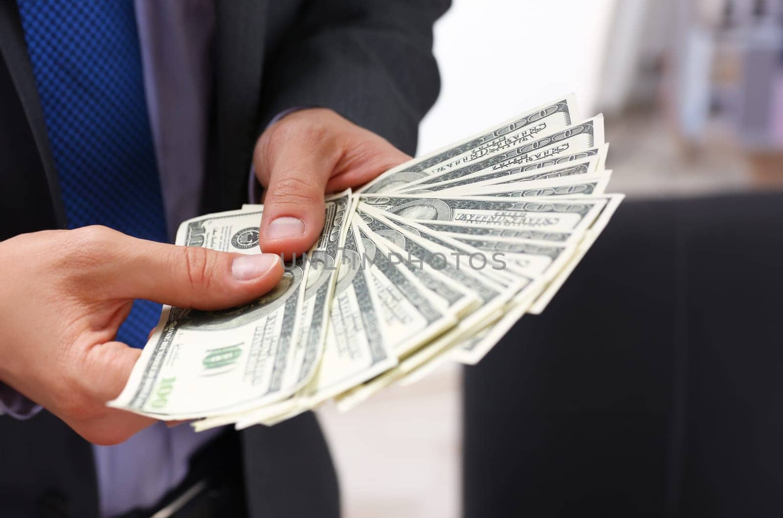 Man in suit and tie hold in arm pack of hundred dollar bills closeup. Stock market exchange earn pile rich present gift employer prepayment service gratitude concept