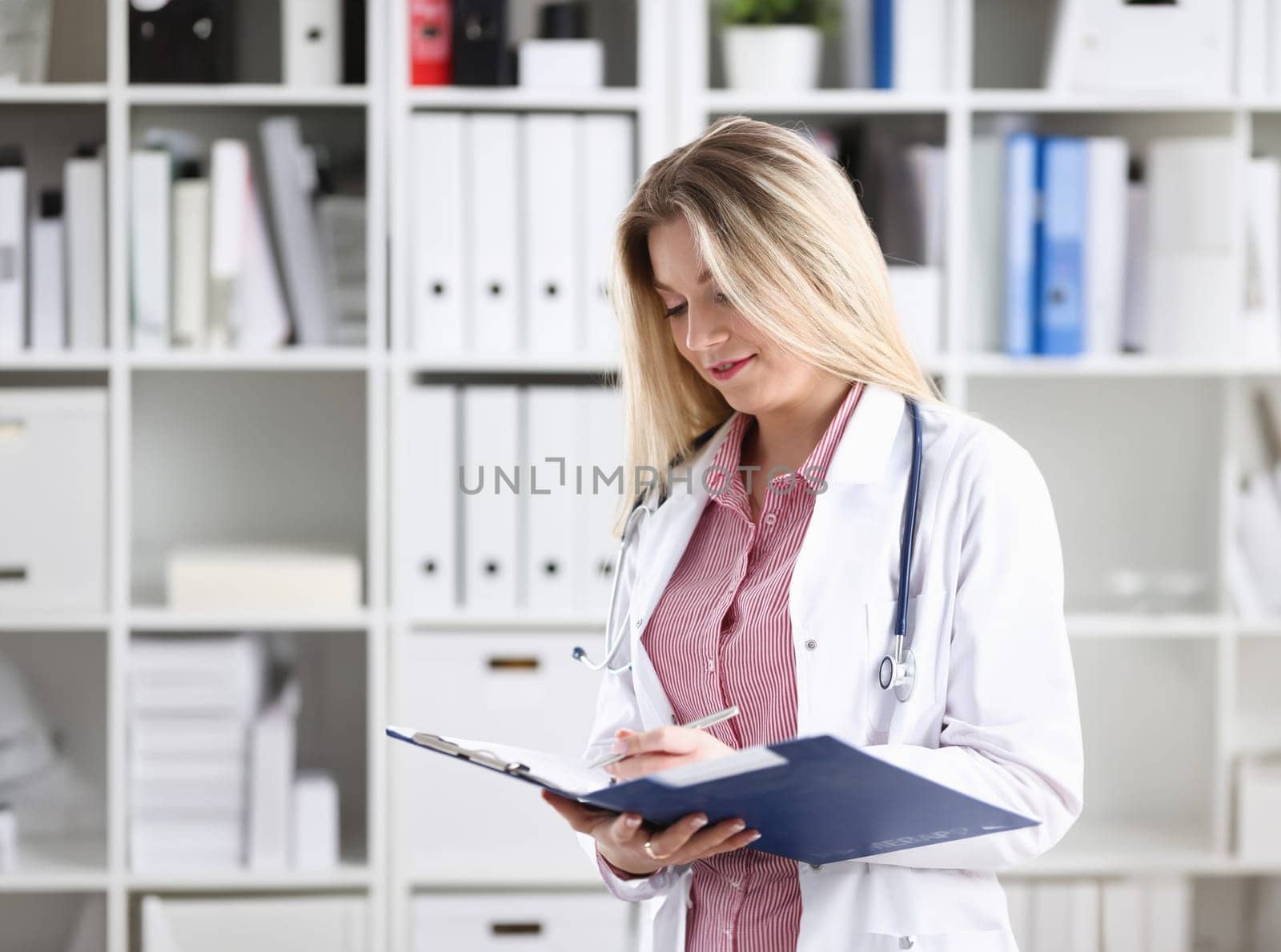 Female medicine doctor hand hold jar of pills and write prescription to patient at worktable. Panacea and life save, prescribing treatment, legal drug store concept. Empty form ready to be used