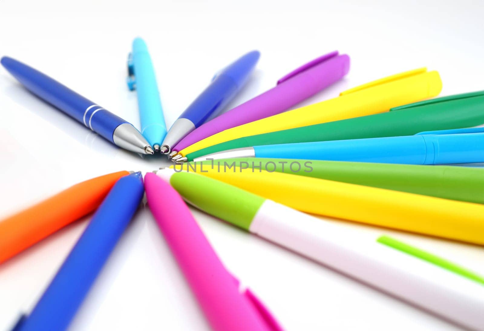 Multicolored ball point pens isolated on white background
