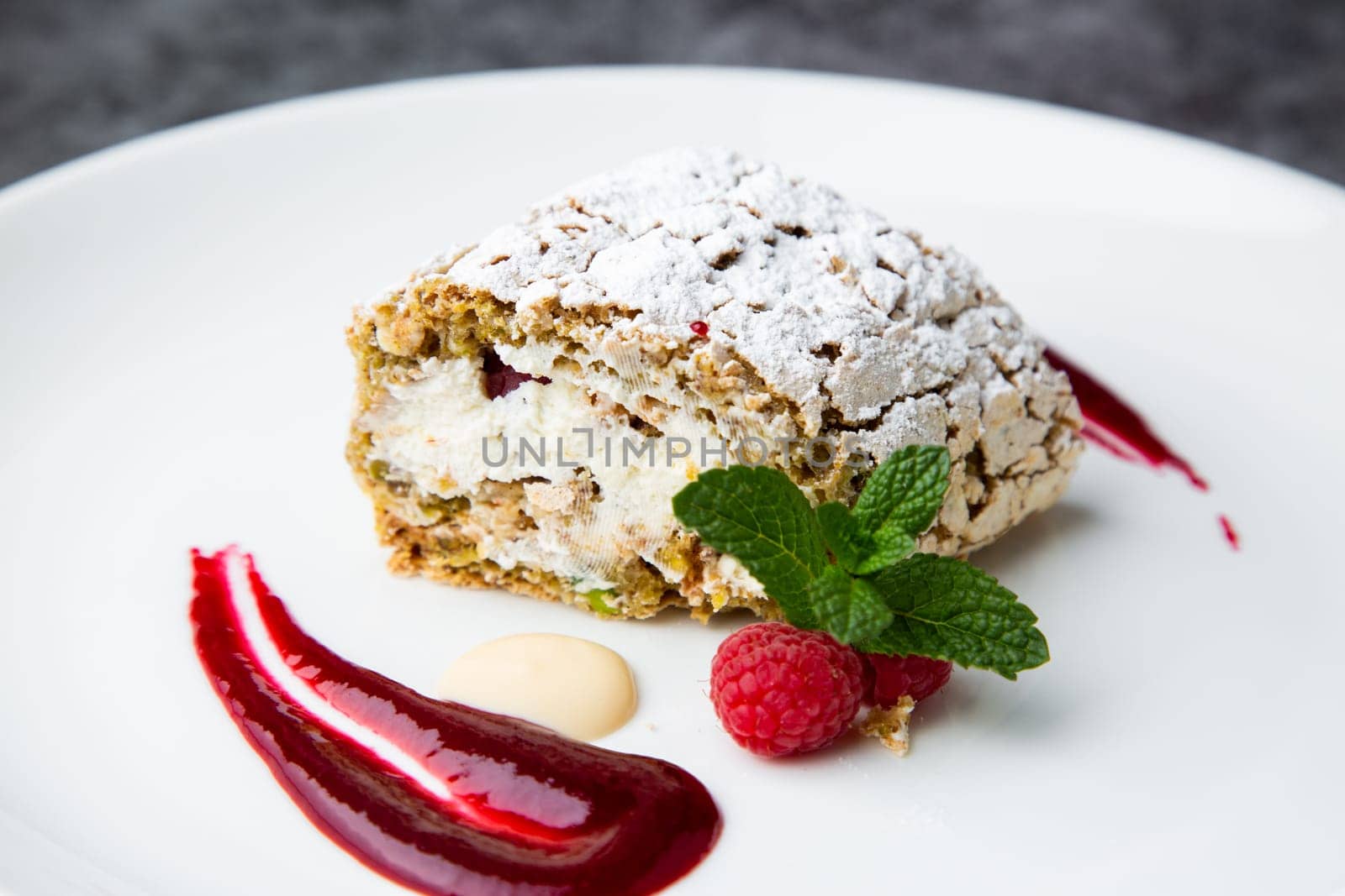 sweet sponge dessert with raspberries and powdered sugar