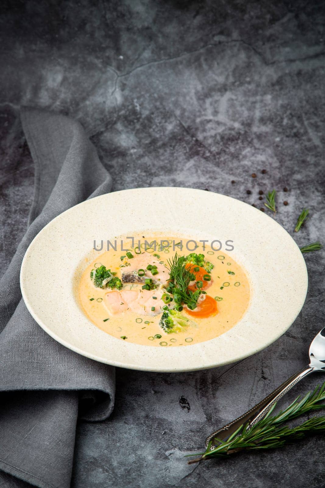 fish soup with green onions, carrots and broccoli side view by tewolf