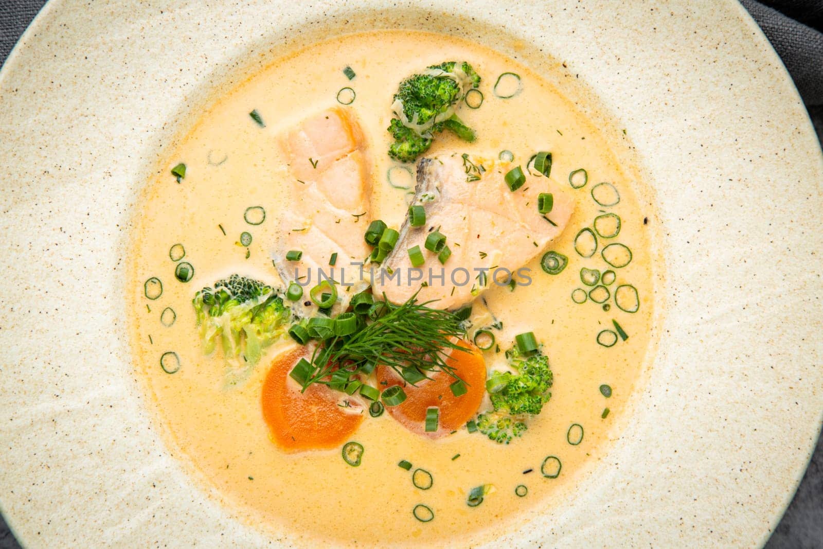 fish soup with green onions, carrots and broccoli