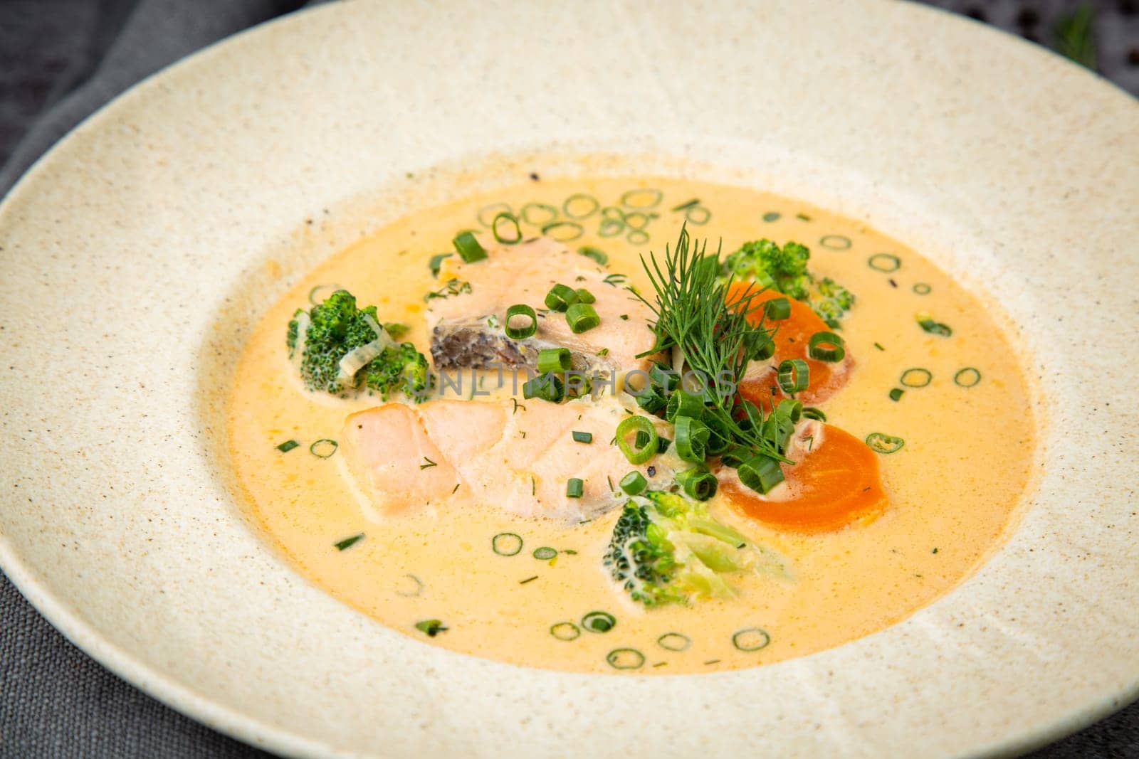 fish soup with green onions, carrots and broccoli