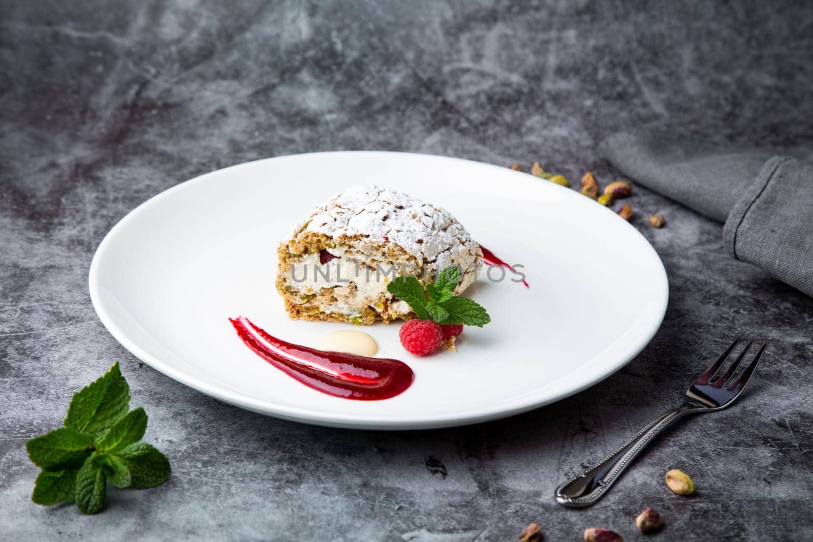 sweet sponge dessert with raspberries and powdered sugar