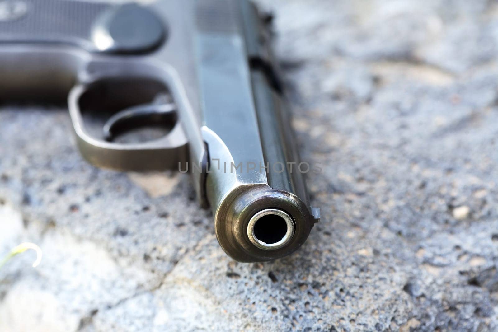 Handgun closeup on gray stone background