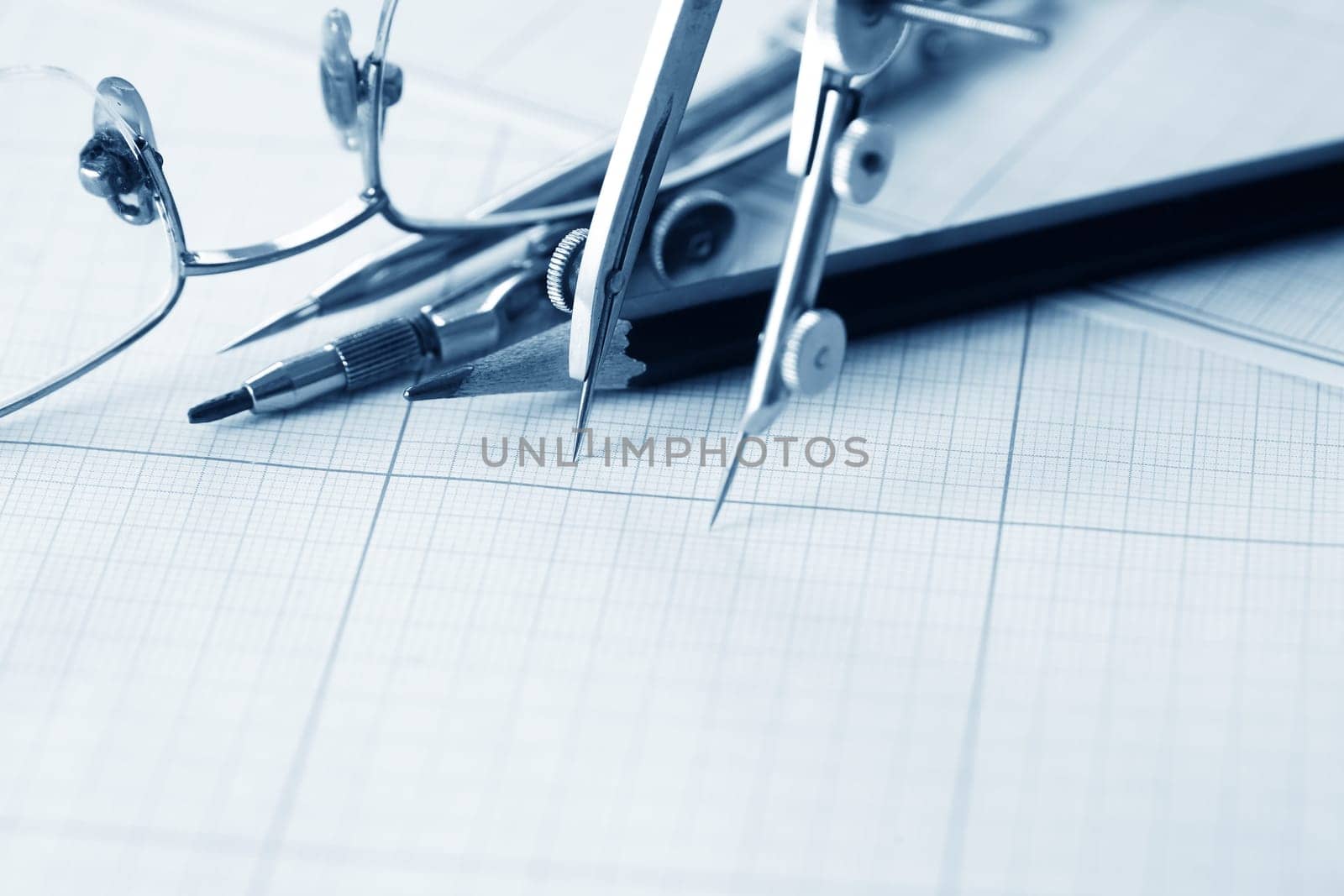 Set of old drawing tools on background with graph paper