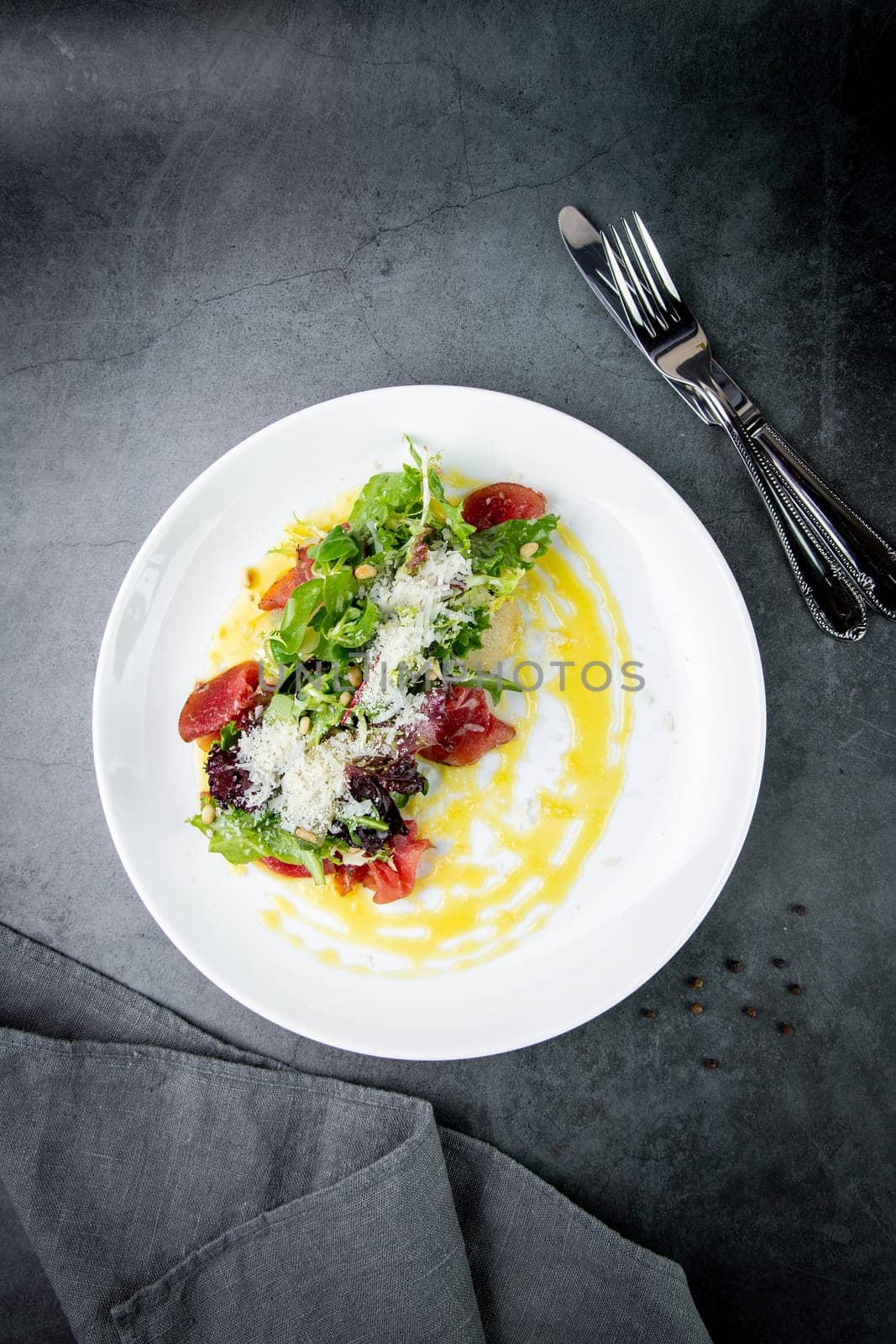 salad with red cabbage, meat, cheese and herbs with sauce