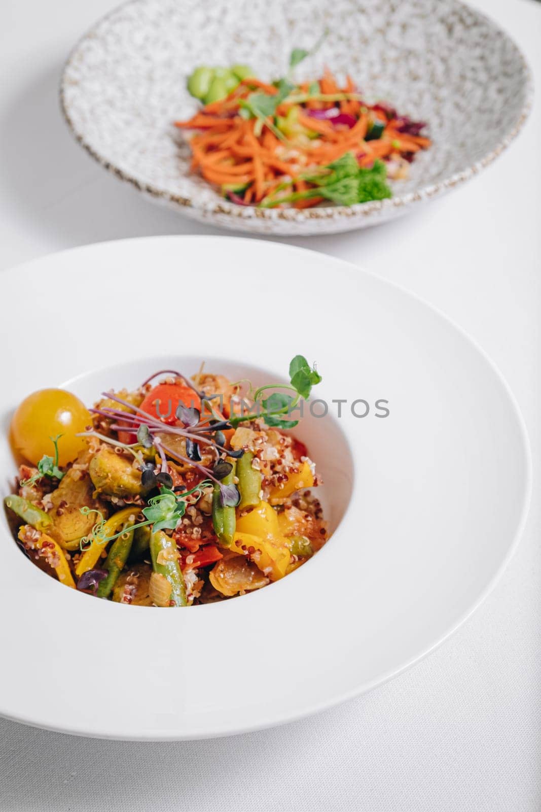 vegetable stew with potatoes, tomatoes and herbs with sauce in a deep plate side view by tewolf