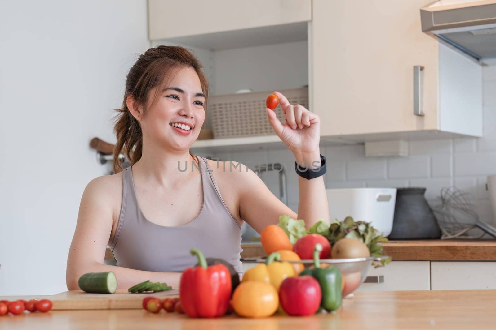Sporty young woman is preparing healthy food on light kitchen. healthy food concept. by wichayada