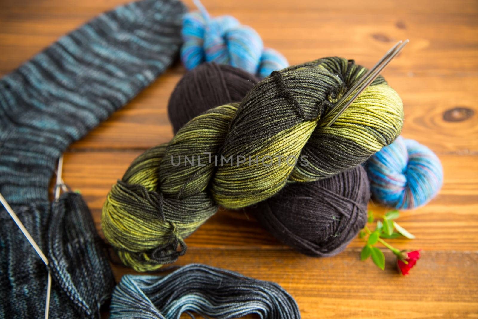 Colored threads, knitting needles and other items for hand knitting by Rawlik