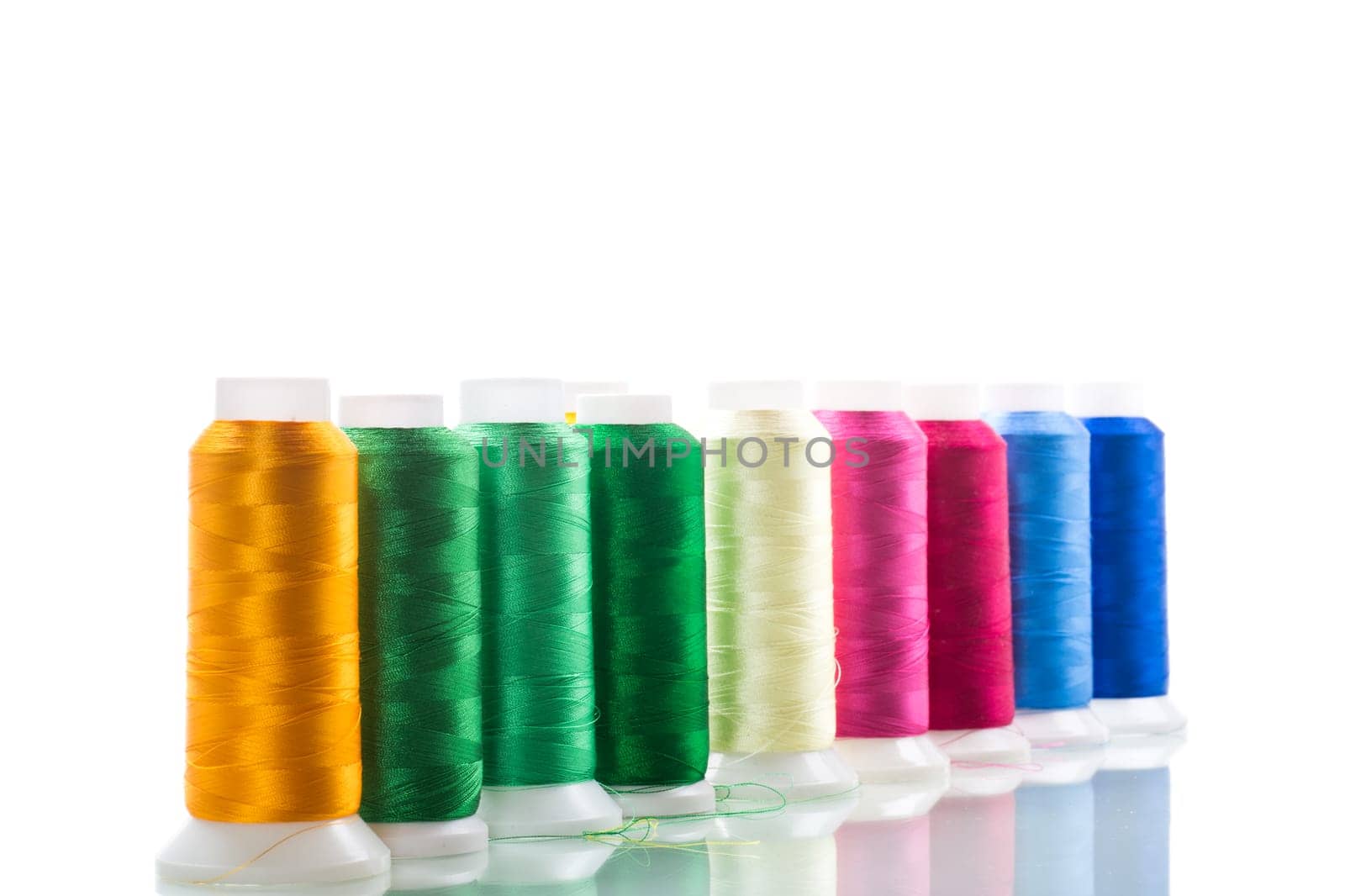 set of different color sewing threads,on white background. by Rawlik