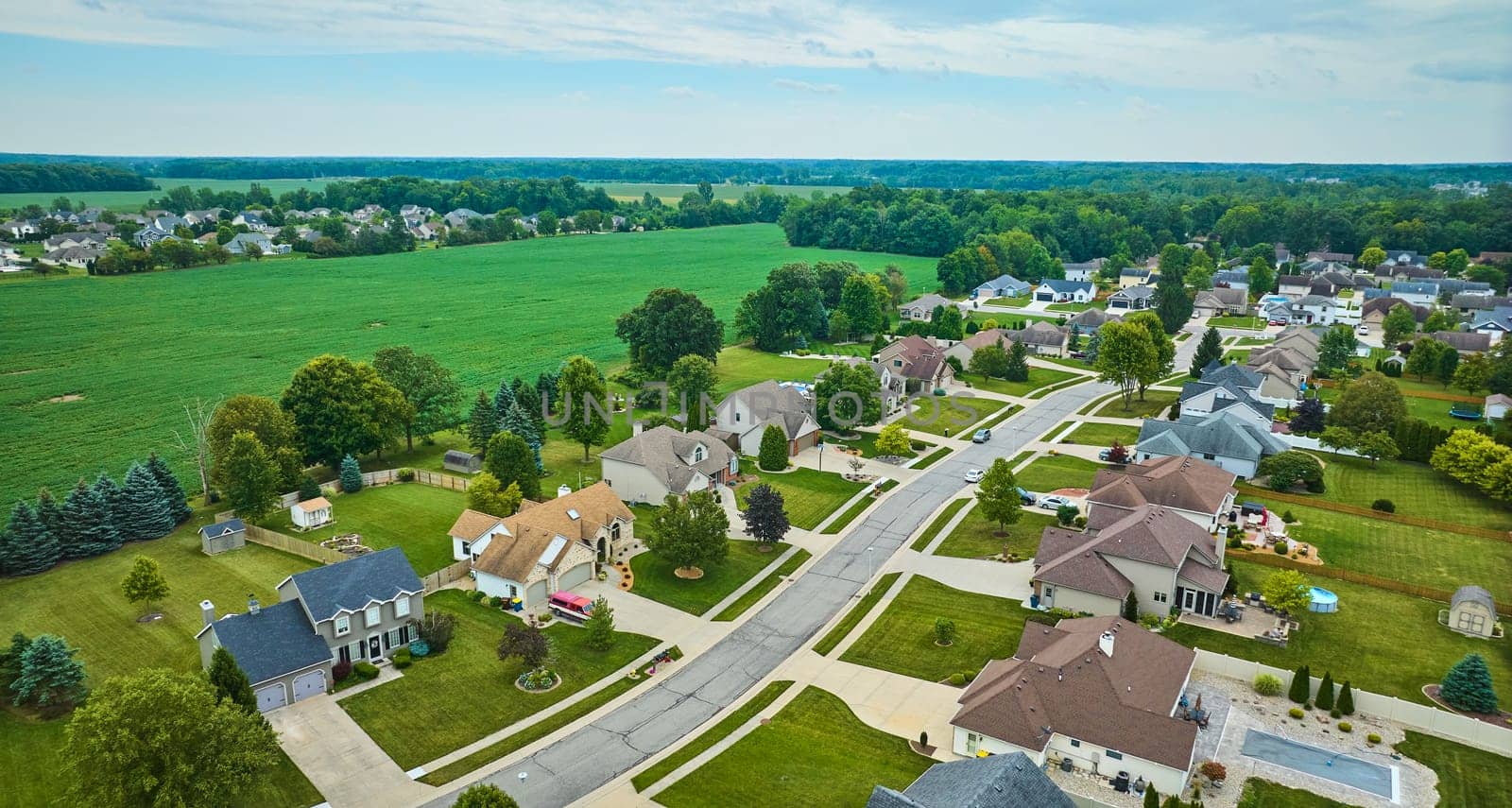 Image of Aerial rural neighborhood with farmland between neighborhoods