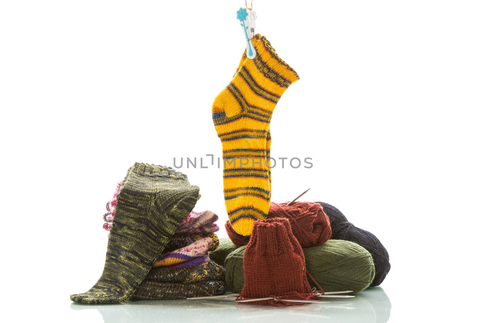 Colored threads, knitting needles and other items for hand knitting, isolated on a white background.