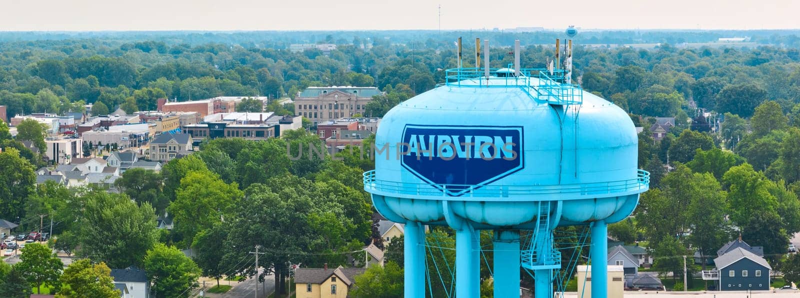 Wide panoramic view of Auburn downtown with focus on bright blue water tower aerial by njproductions