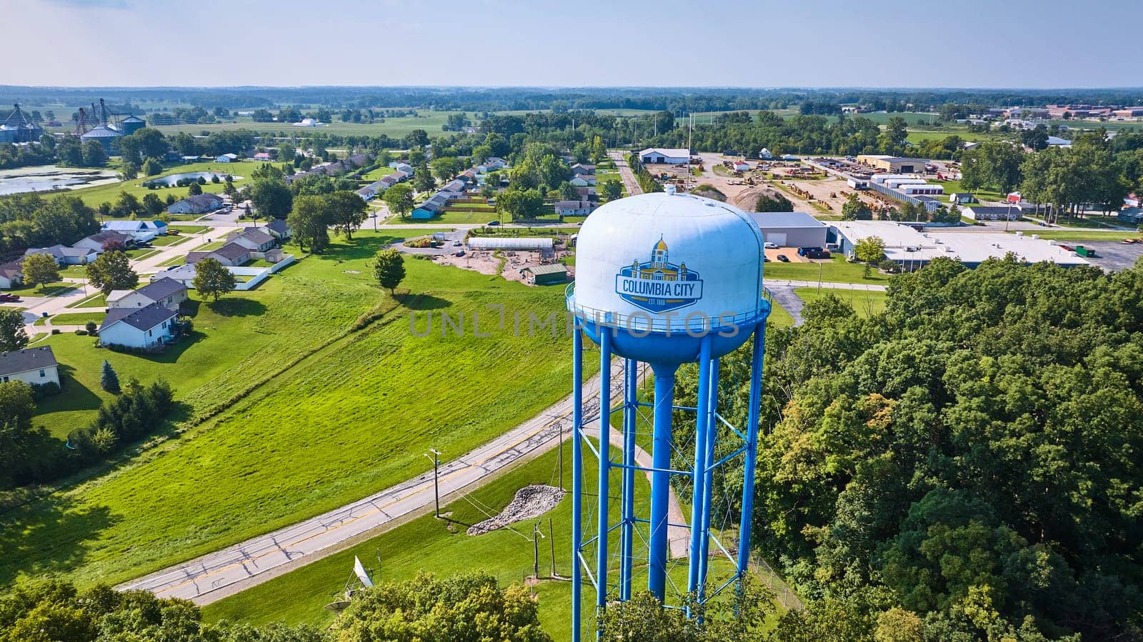 Image of Columbia City water tower aerial with neighborhood and industrial area in background
