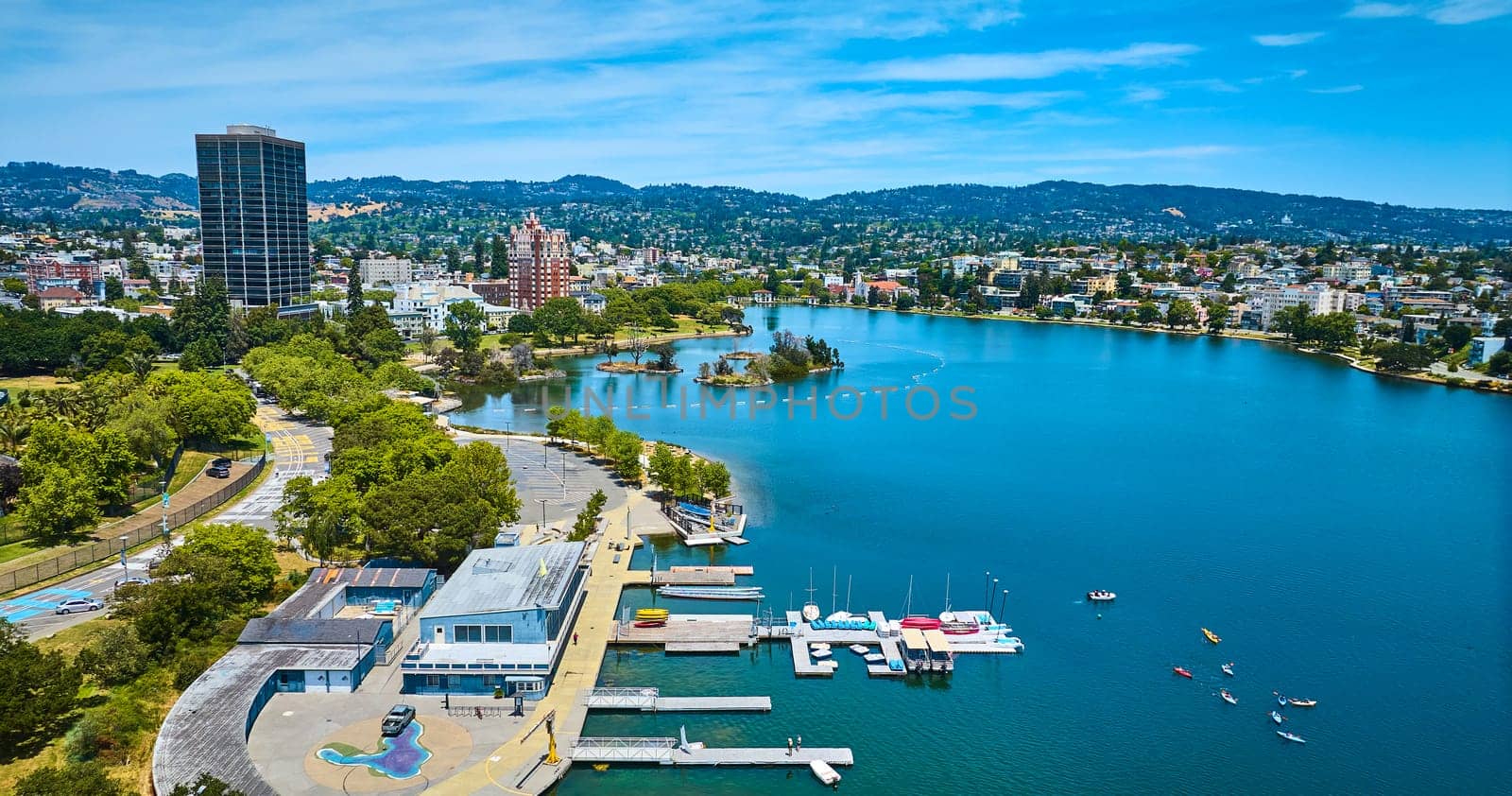 Image of Aerial boating center on Lake Merritt with Pelican Island in distance with buildings along shore