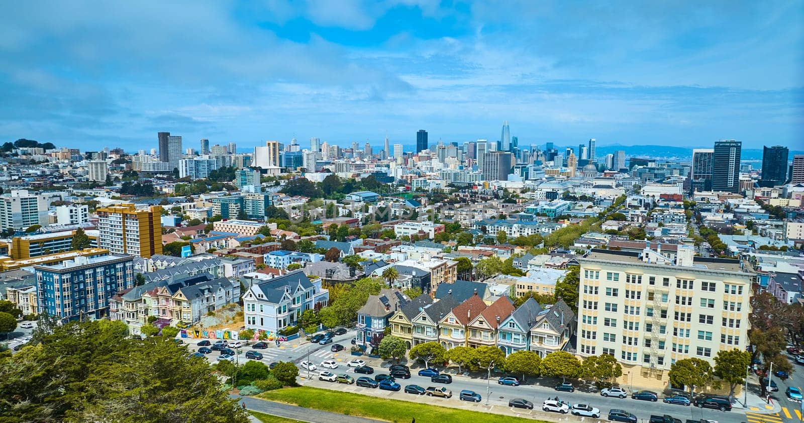 Image of Aerial San Francisco The Painted Ladies with wide view of city and skyscrapers under pretty sky