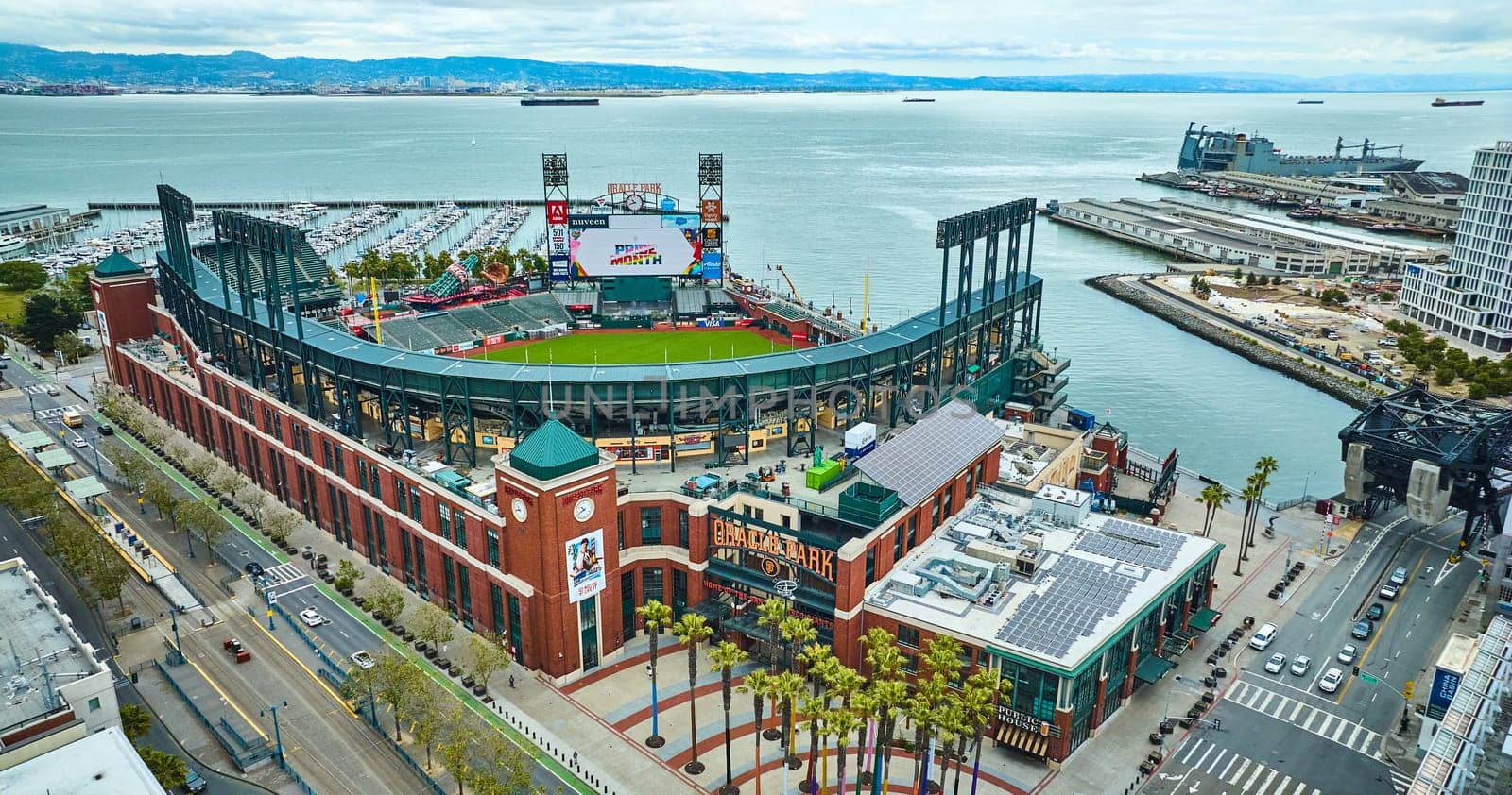 Image of Aerial Oracle Park Willie Mays Gate entrance with ballpark and South Beach Harbor