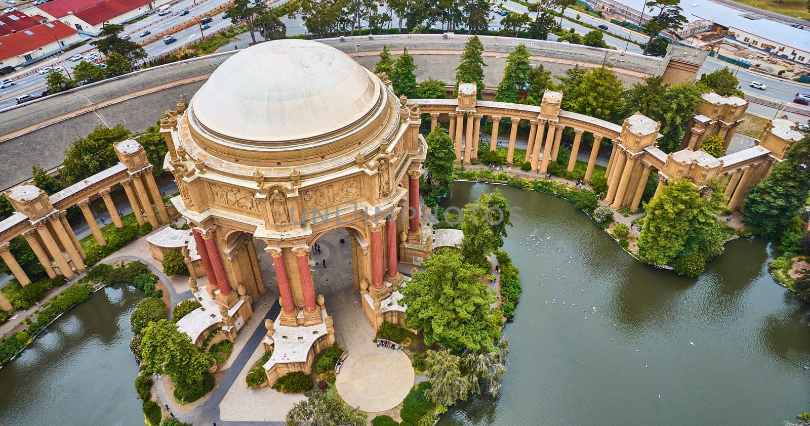 Image of Palace of Fine Arts rotunda and colonnade around lagoon in downward aerial