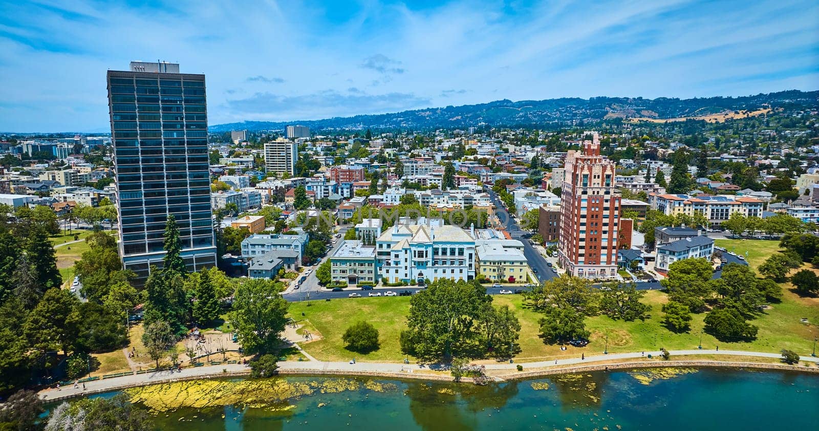 Image of Residential aerial of Oakland City with Lake Merritt shore and distant hilly horizon