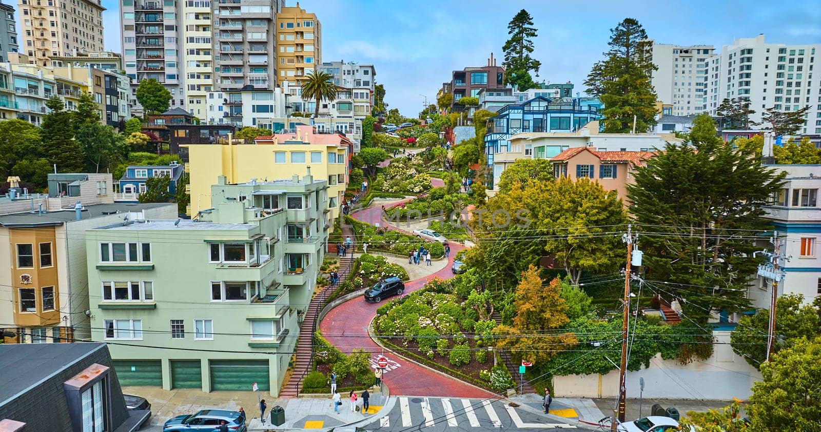 Image of Lower aerial angle on Lombard Street with cars and people coming down hill