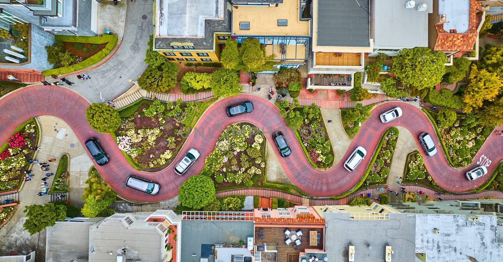 Image of Aerial straight down over Lombard Street with cars and road running horizontally