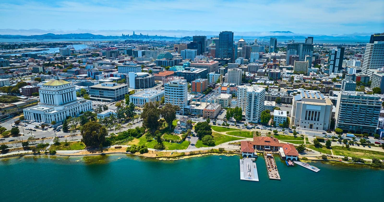 Image of Aerial with restaurant and downtown Oakland courthouse with distant San Francisco skyscrapers