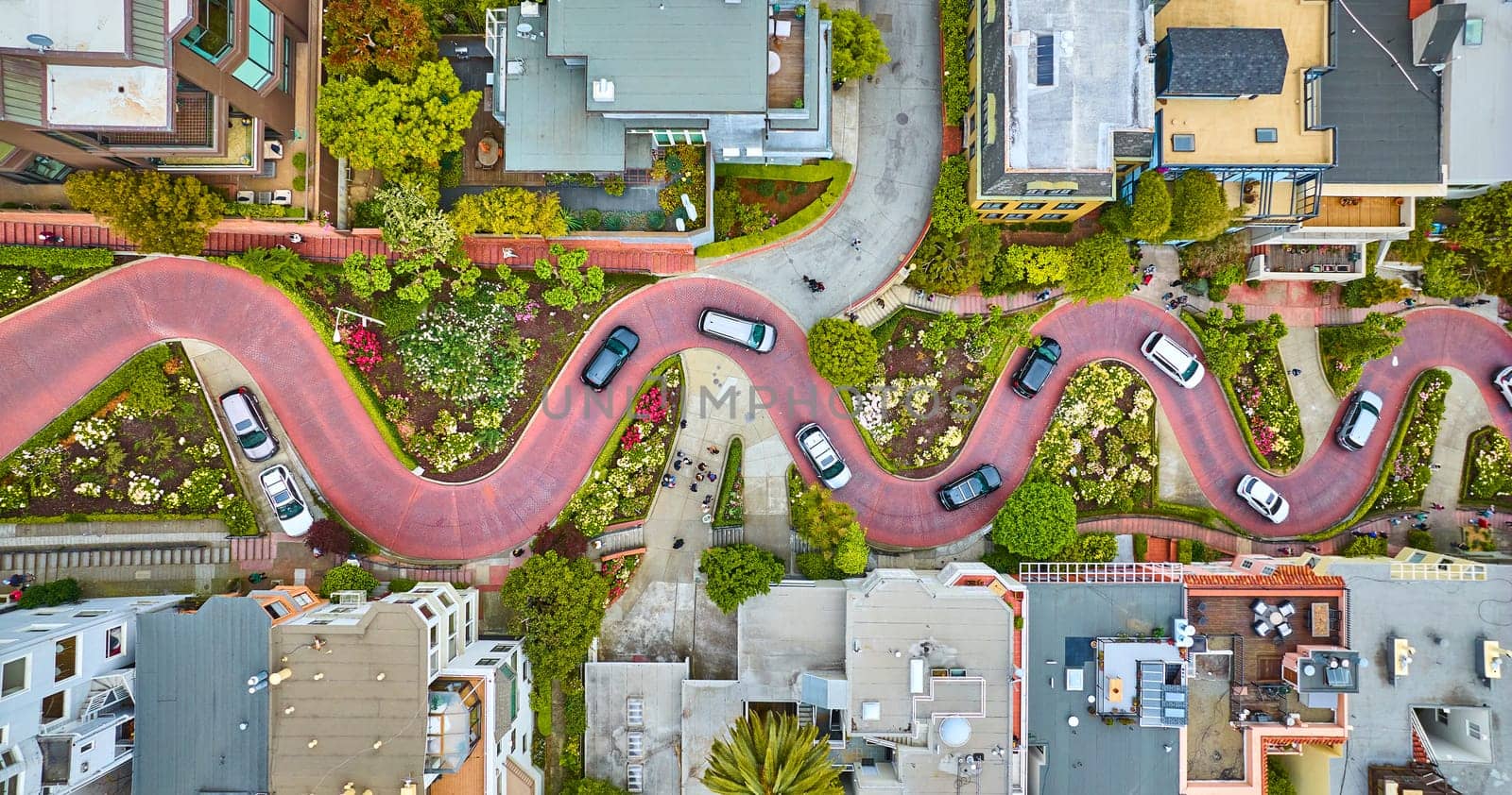 Image of Straight down aerial over Lombard Street with cars and road running horizontally through shot