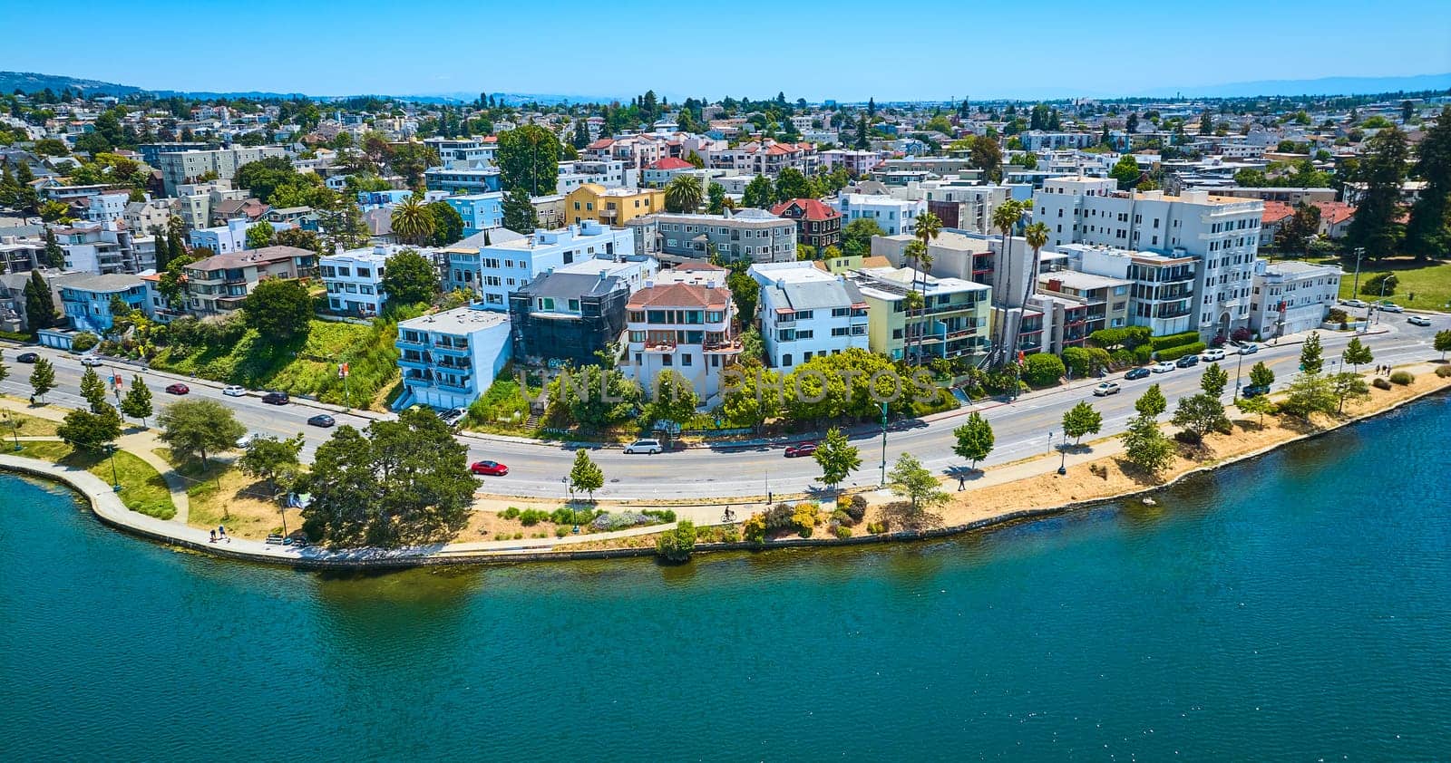 Image of Oakland aerial of residential area with road along lakeshore and blue sky